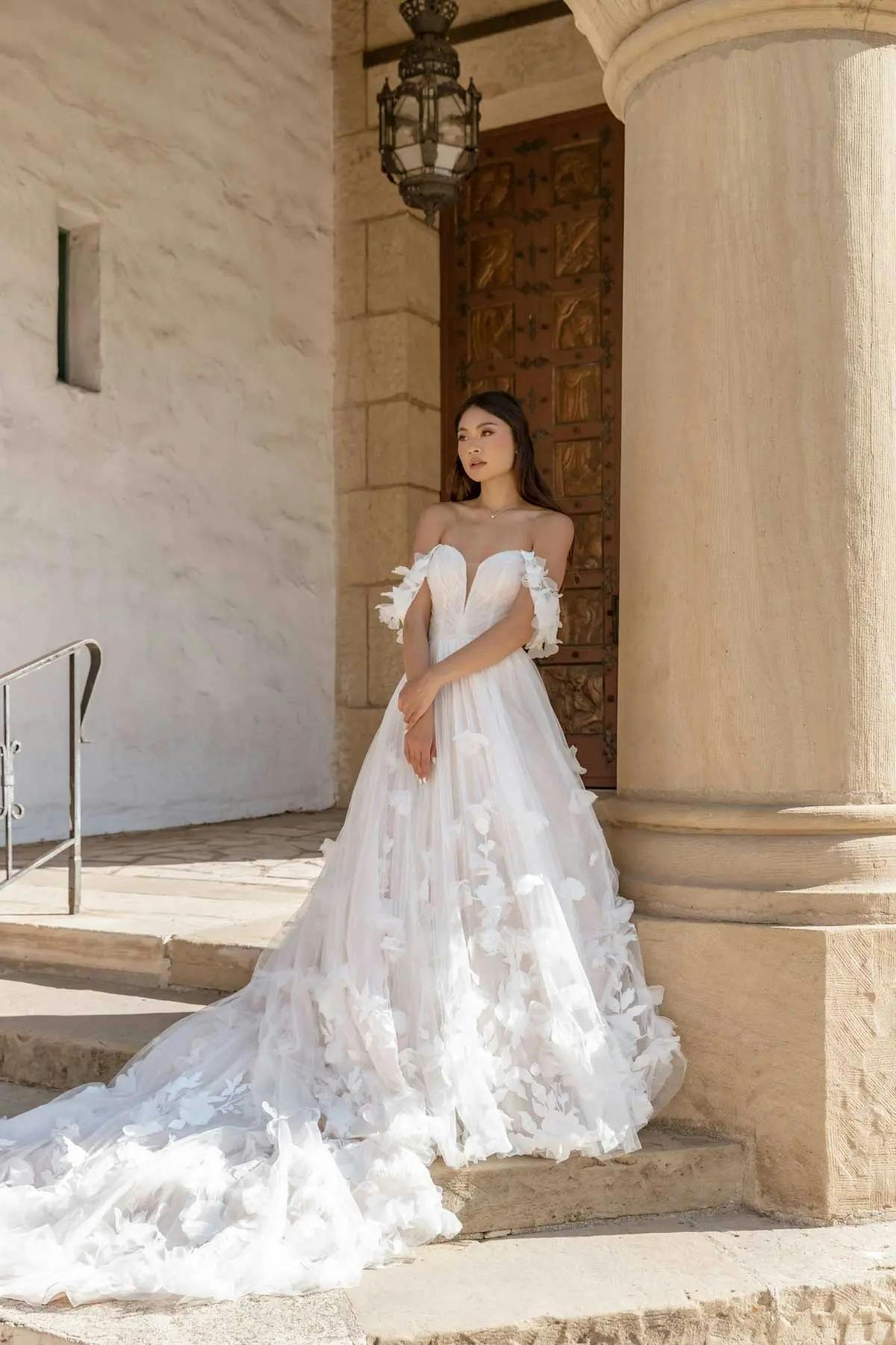 Picture of Essense dress on bride outside on stone steps