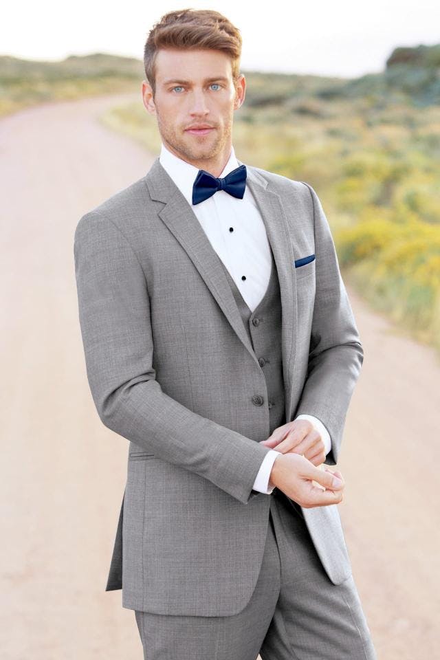 Picture of man in light grey tux on dirt road