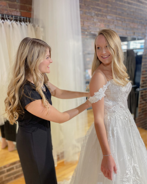 Picture of consultent putting dress on the most beautiful bride you've ever seen!